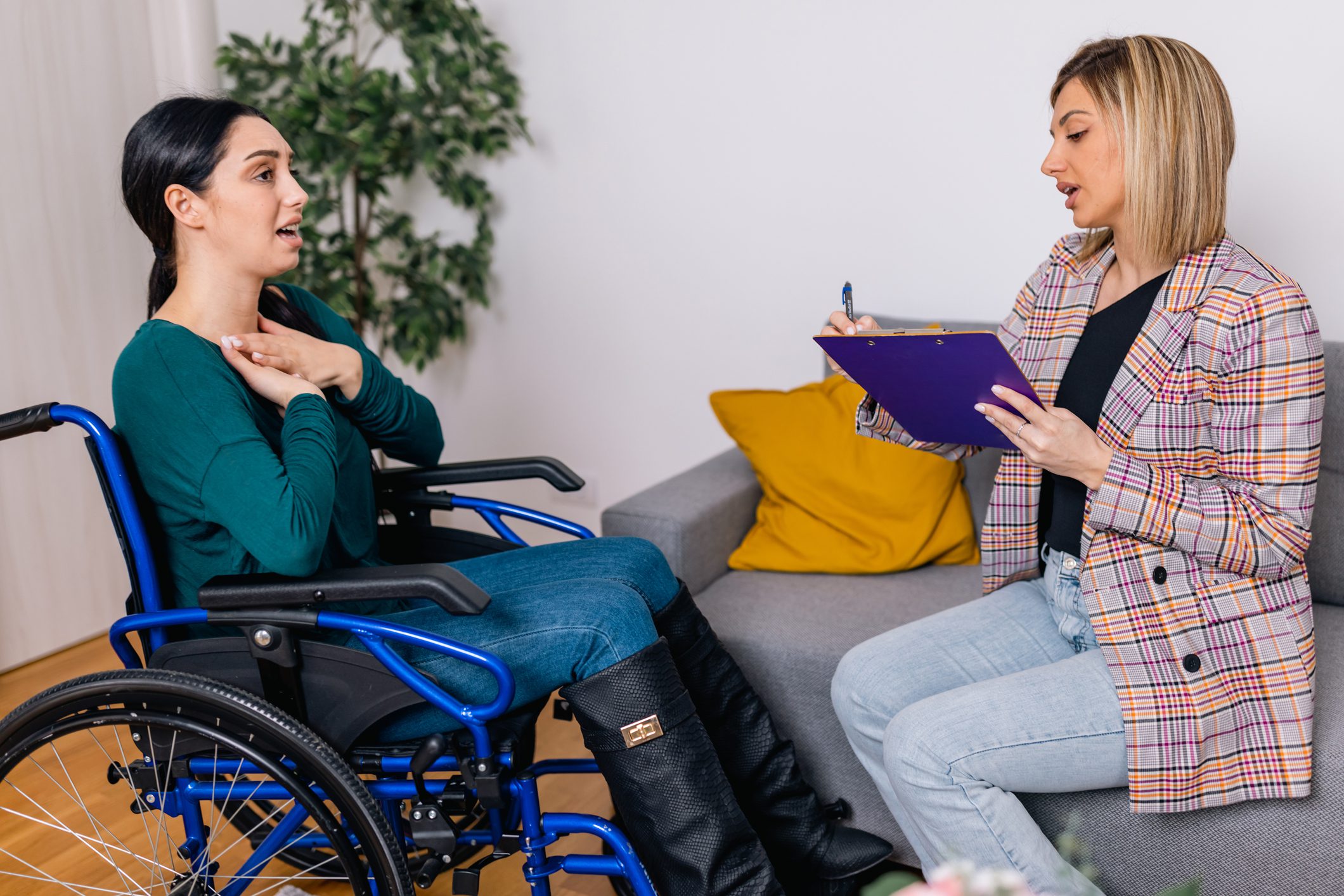 Embracing inclusivity, a young Caucasian woman in a wheelchair engages in healing therapy sessions, where she finds solace and understanding through the guidance of her empathetic psychotherapist